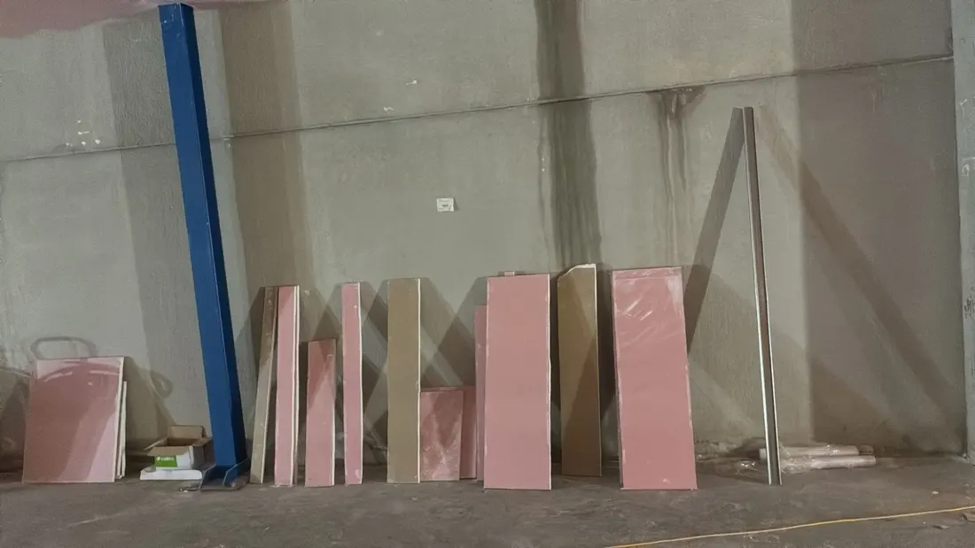 Restos de placas de pladur apoyadas en la pared de una nave